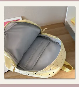 Detailed view of the cute yellow student backpack interior structure with star print.