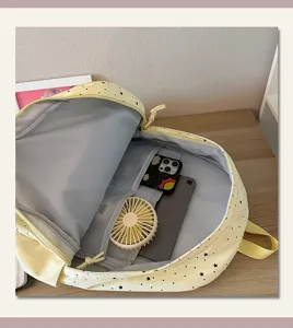 Yellow star print backpack interior detail view displaying spacious compartments and pockets.