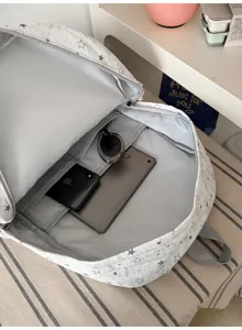 Detail view of interior storage pockets and compartments of the casual star print canvas backpack.