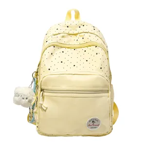 Cute light yellow backpack with black stars and plush cat pendant for daily school use.