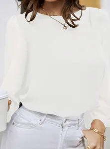 Detailed view of the elegant white long-sleeve blouse, stylish drape and minimalist design.