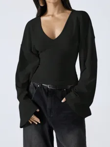 Close-up detail of the black V-neck drop-shoulder long bell sleeve top in daily wear.