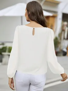 Elegant white long sleeve blouse for women, casual commuter chic top with button back.