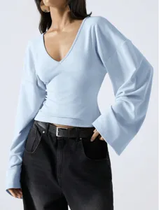 Light blue V-neck drop shoulder bell sleeve top close-up showing relaxed fit and elegant design.