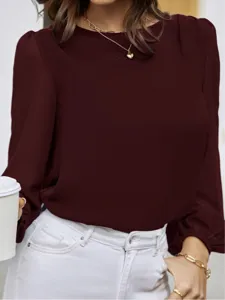Elegant burgundy long sleeve blouse detail, minimalist crewneck design for professional commuting wear.
