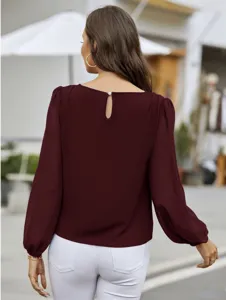 Burgundy long sleeve blouse featuring back keyhole button design. Draping slim fit commute top.
