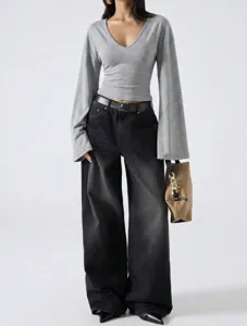 V-neck loose bell-sleeve top and wide-leg denim pants detail showcasing chic minimalist style.