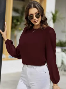 Detail view of the elegant burgundy long-sleeve blouse featuring chic lantern sleeves.
