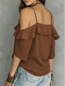 Detailed view of brown cold-shoulder blouse with spaghetti straps and chic ruffles for vacation.