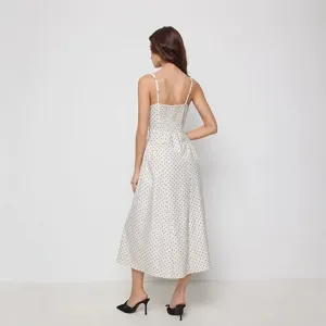 Detailed view of the back of the polka dot camisole dress showing elastic bodice and straps.
