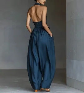 Backless halter jumpsuit featuring high waist and wide lantern legs for chic resort styling.