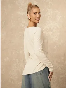 Detail shot of the solid color long sleeve slim top, showcasing the side gathered design.