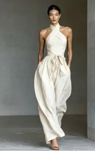 Off-white halter neck backless wide leg jumpsuit, high waist tie detail, vacation style.