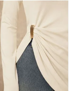 Solid color long sleeve top featuring a stylish side metal buckle detail for casual wear.