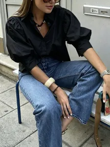 Detail view of stylish black French puff sleeve casual shirt featuring lapel and loose fit.