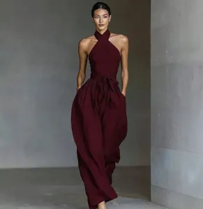 Close-up detail of the elegant burgundy halter neck jumpsuit showing the stylish waist tie.