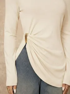 Beige long sleeve top detail featuring side metal buckle and stylish gathered design.