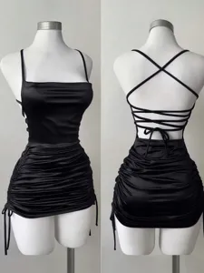 Black satin mini dress detail, square neck, backless lace-up straps, ruched drawstring.