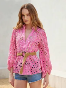 Pink embroidered hollow-out long-sleeve blouse detail, featuring ruffled stand collar.