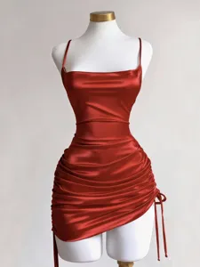 Red satin dress detail showing adjustable side drawstring and ruched bodycon hemline.
