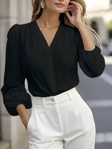 Elegant V-neck blouse with 3/4 puff sleeves, professional and chic for work styling.