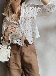 Detailed view of the white eyelet embroidered short blouse, showing delicate fabric texture and fit.