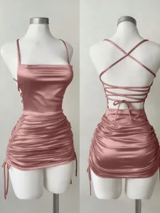 Sexy satin slip mini dress featuring square neck, open back lace-up straps and ruched side.