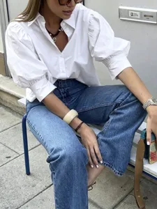 Detailed view of women's white French puff sleeve casual shirt with classic lapel design.