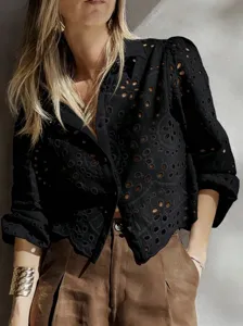 Detailed view of women's black hollow embroidery short shirt, French style vacation casual wear.
