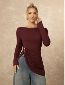 Detail view of a slim-fit long-sleeve solid color top with elegant gold-tone ring side accent.