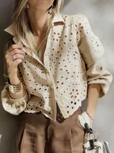 Detailed view of the beige eyelet embroidered short shirt showing exquisite craftsmanship.