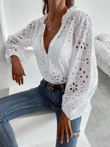 Close-up of white eyelet embroidered blouse, V-neck, lantern long sleeves, casual chic style.