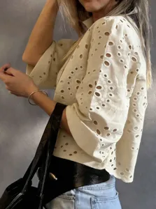 Detailed shot of white eyelet embroidered short blouse, French pastoral vacation style.