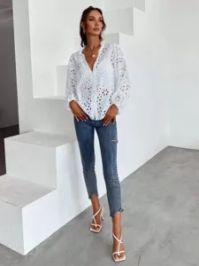 White eyelet embroidered long sleeve blouse with ruffle stand collar and delicate V-neck design.