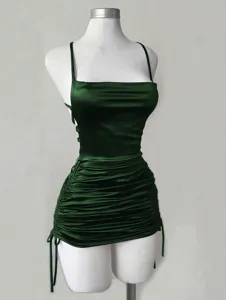 Detailed view of the dark green satin mini dress, featuring a square neck and adjustable drawstrings.