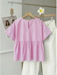 Pink and white vertical striped short sleeve blouse with a loose flared A-line hem detail.