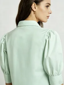 Mint green puff sleeve shirt detail showcasing the stylish lapel and elastic cuffs design.