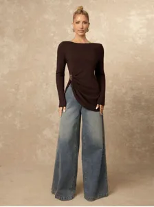 Detail shot of stylish long sleeve top combined with casual wide leg denim jeans.