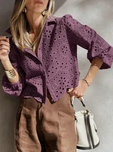 Close-up detail view of the purple eyelet embroidered cropped blouse with bubble sleeves.