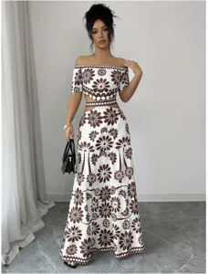 Detail view of the elegant brown and white floral off-shoulder crop top and tiered skirt.