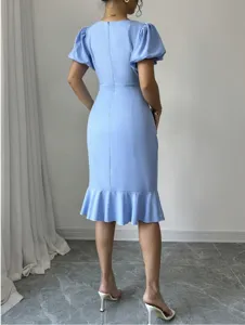 Light blue midi dress featuring puff sleeves, fitted bodice, and elegant fishtail hem style.