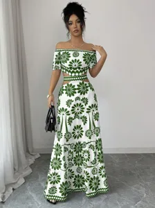 Off-the-shoulder green floral two-piece dress with cutout high waist and tiered hem maxi skirt.