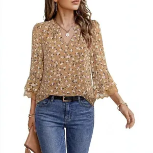 Detail view of the elegant brown floral long sleeve blouse with delicate lace trim cuffs.