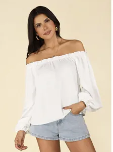 Detailed shot of a stylish white off-the-shoulder long sleeve top paired with denim shorts.