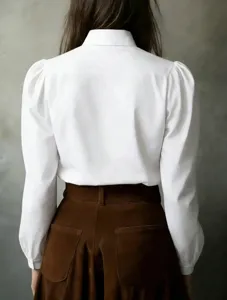 Detail view of the elegant white long sleeve blouse with puff sleeves for women.