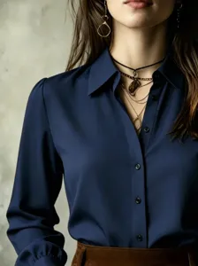 Close-up detail of women's long sleeve navy blue button-down shirt with classic collar.
