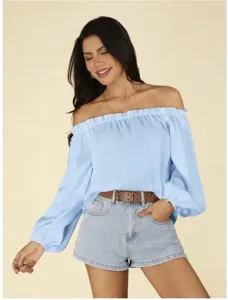 Details of light blue off-the-shoulder long sleeve blouse with ruffled neckline and denim shorts.