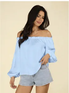Close-up of the light blue off-shoulder long sleeve blouse featuring delicate ruffle trim.