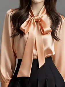 Close-up view of the elegant champagne satin bow tie long sleeve shirt detail shot design.