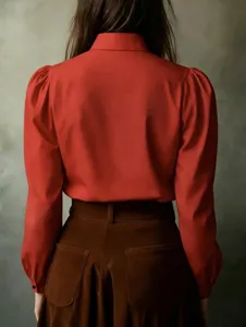 Detail shot showing the back view of a red long sleeve blouse with elegant puffed sleeves.